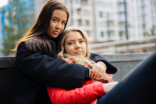 Caring Friend Consoling Unhappy Young Woman In City