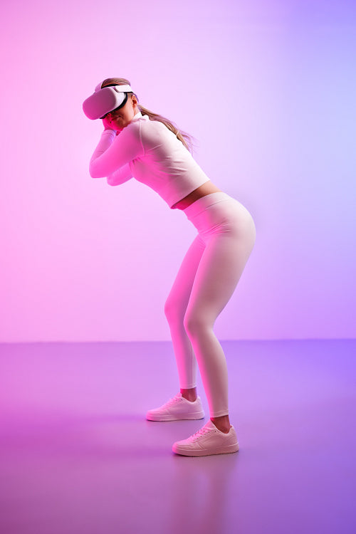 Female wearing VR glasses playing golf