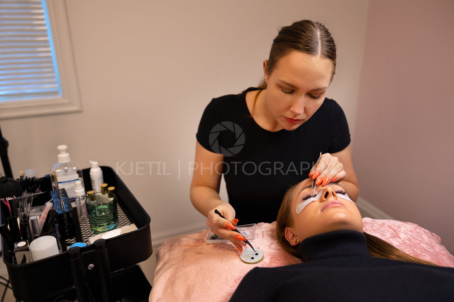 Brunette Beautician Using Tweezers For Eyelash Extension Treatment