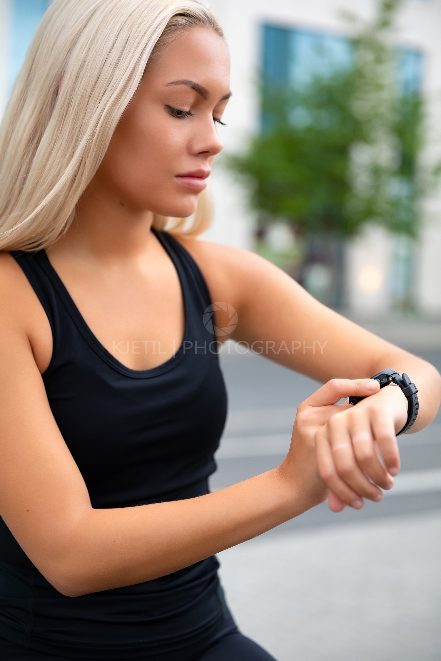 Focused Woman Checking Performance and Tracking On Smartwatch After Exercise