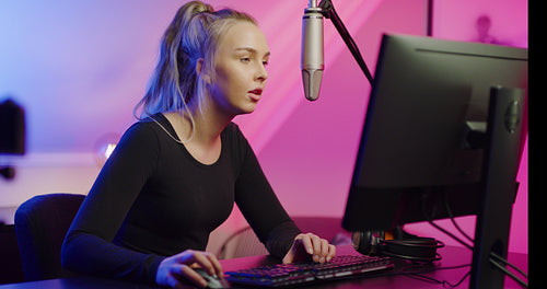 Close-up of Professional E-sport Gamer Girl Streaming and Playing Online Video Game on PC