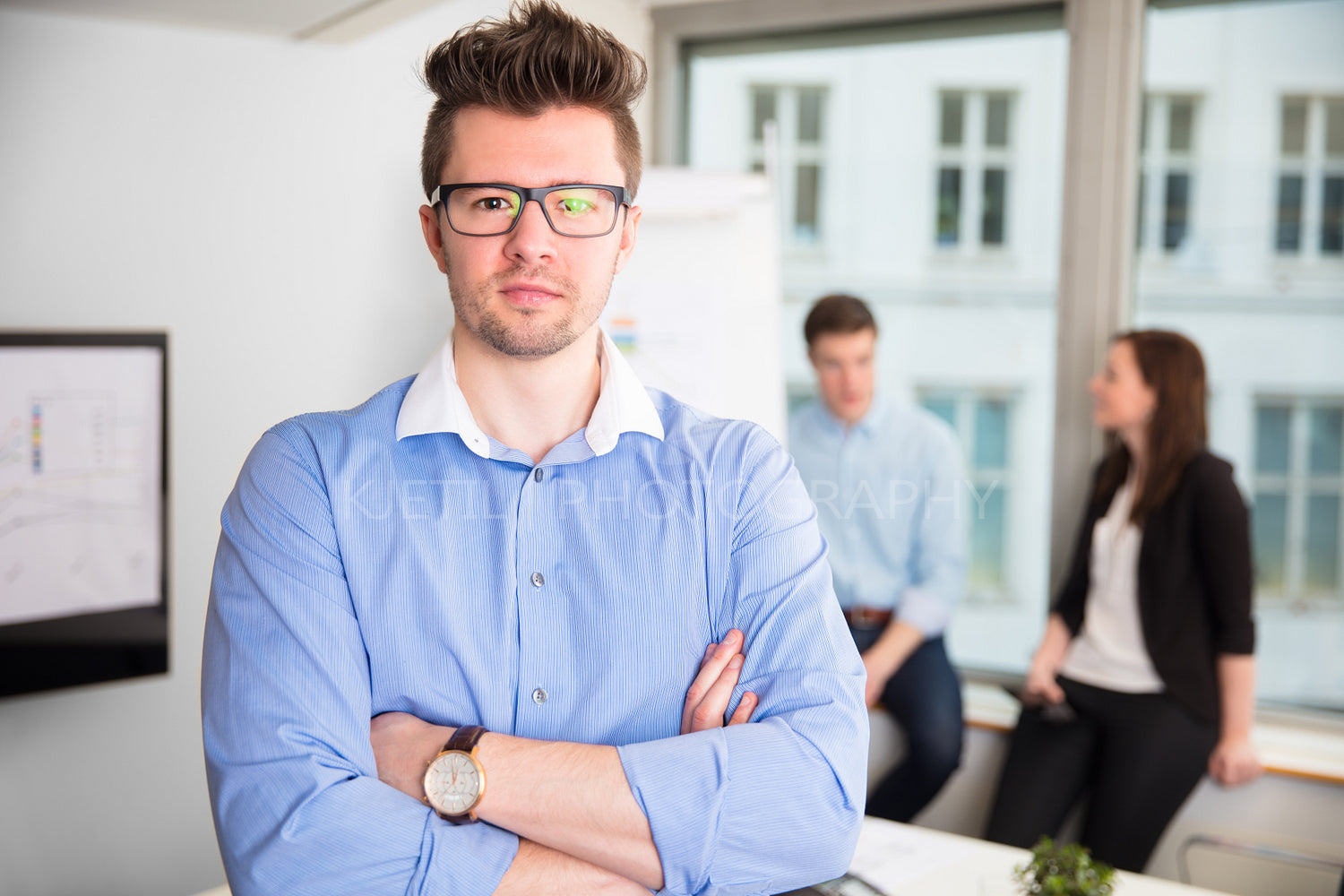 Confident Businessman With Arms Crossed Wearing Eyeglasses