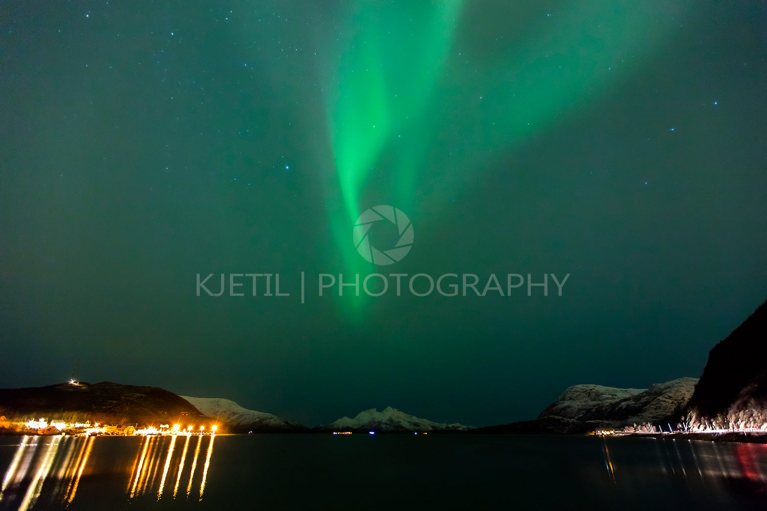 Beautiful northern lights over a fjord at night