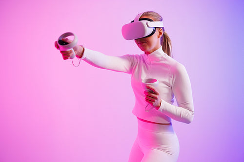 Female athlete in VR glasses practicing martial arts