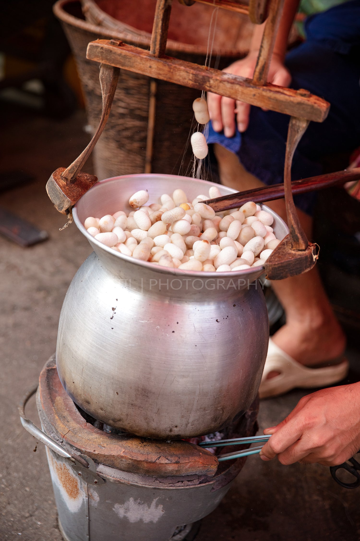 Man Boiling Silk Cocoons In Large Pan