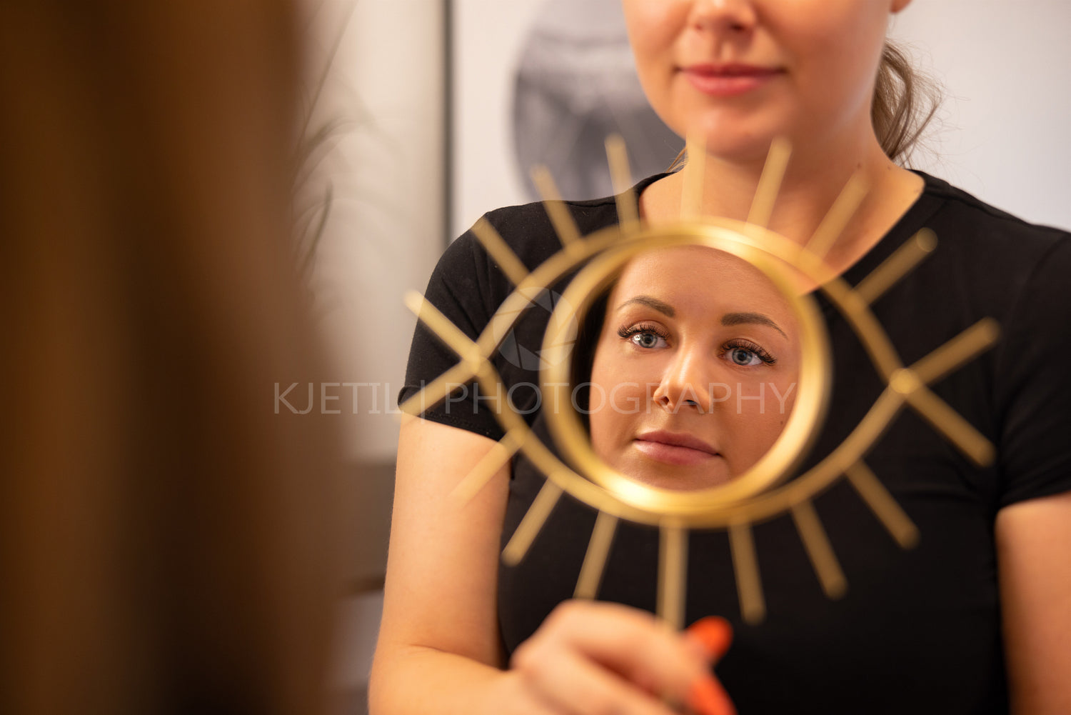 Smiling Beautician Holding Mirror For Female Customer
