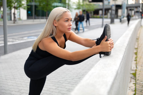 Gorgeous and Flexible Blonde Woman Stretching In Modern City