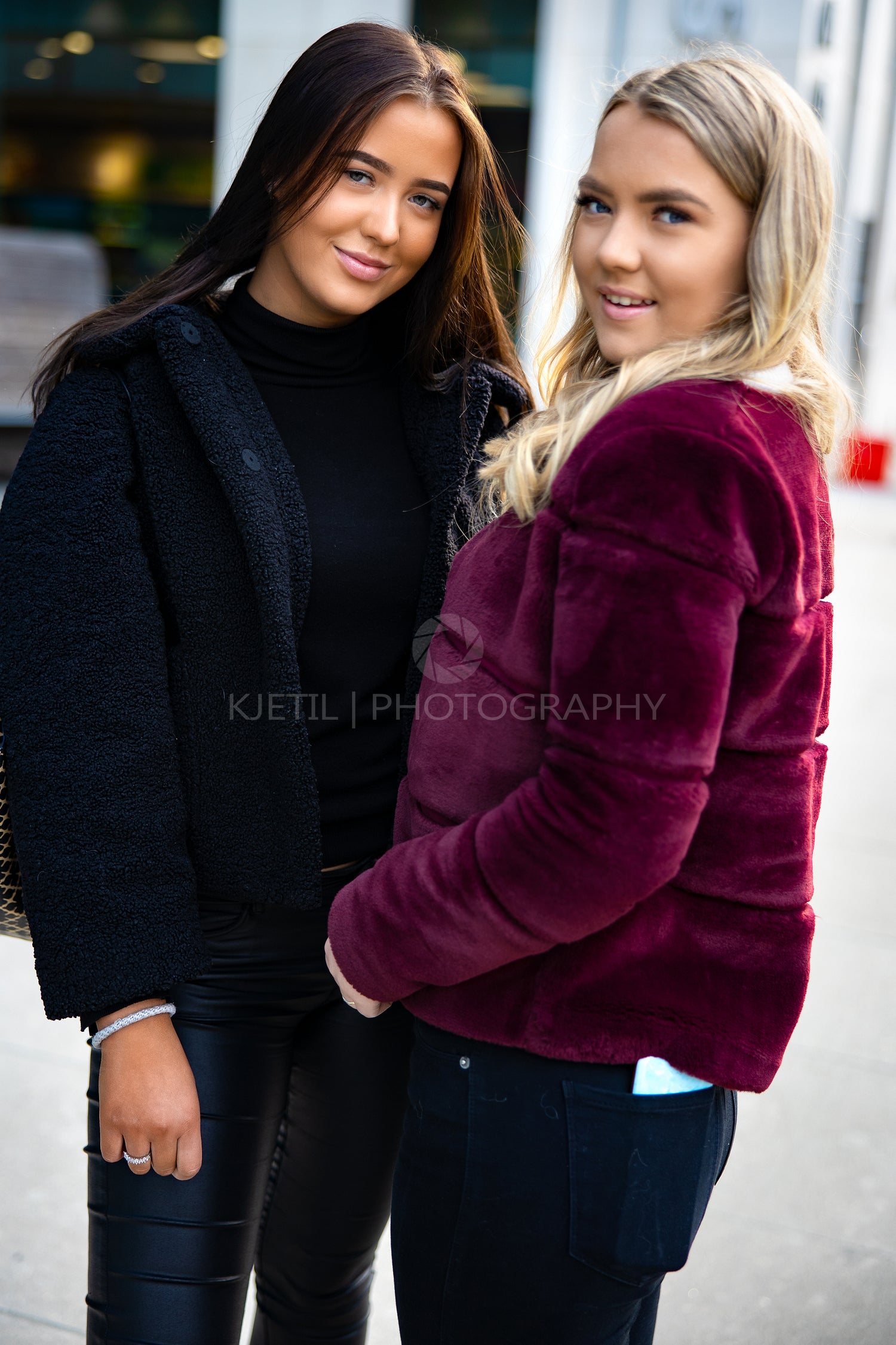 Portrait Of Two Smiling Beautiful Female Friends In City
