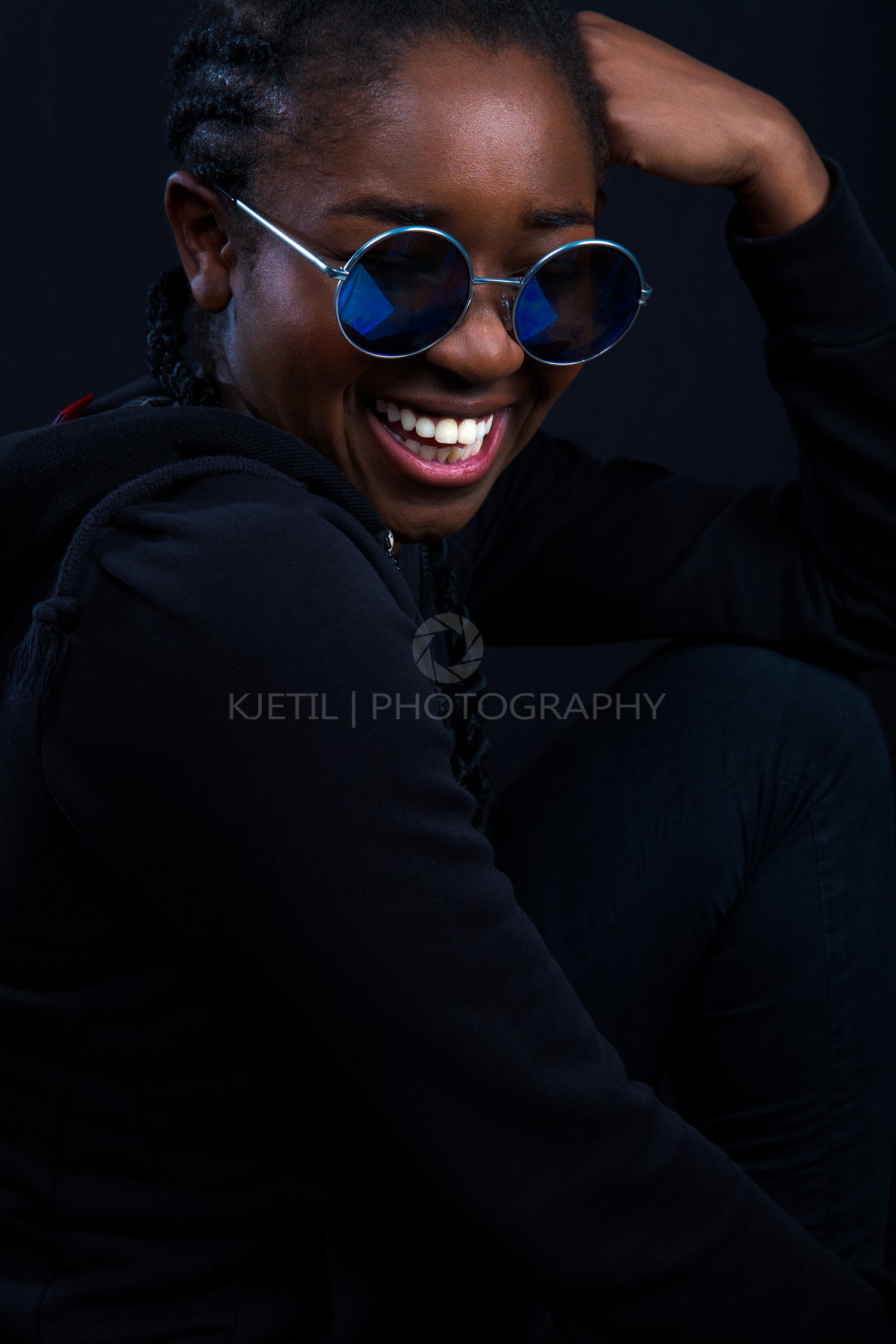 Happy Woman Wearing Sunglasses Over Black Background