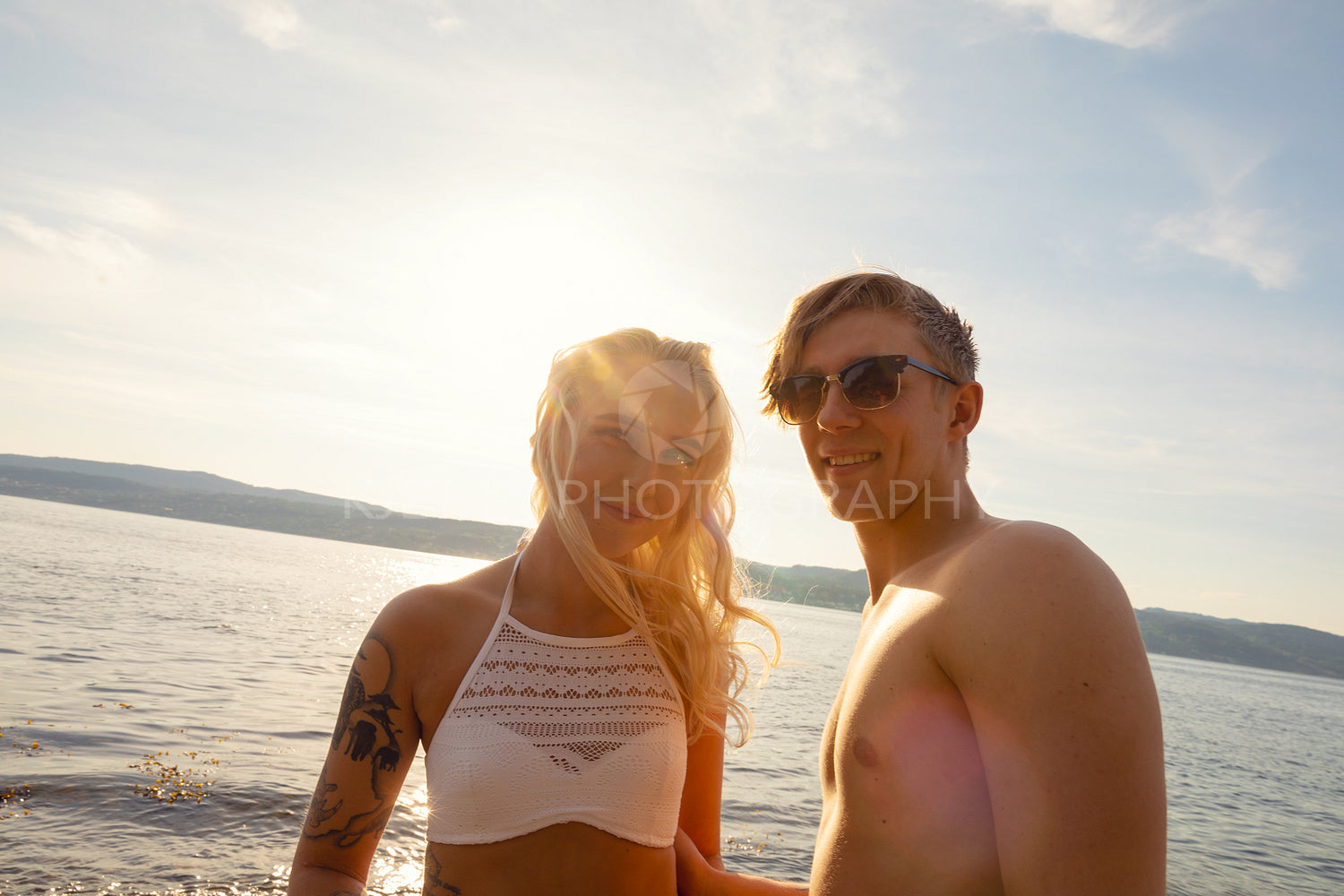Portrait Of Beautiful Smiling Young Man And Woman At Beach