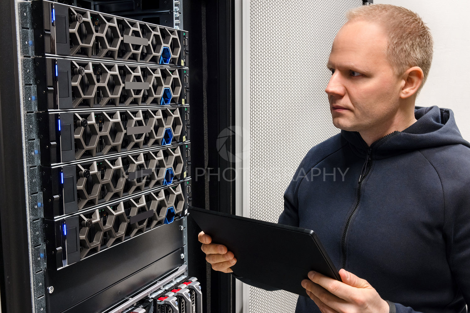 Male Computer Engineer With Digital Tablet Examining Hyperconverged Servers