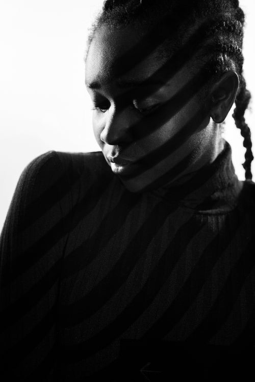 Creative light stripes from a projection on beautiful woman with dark skin