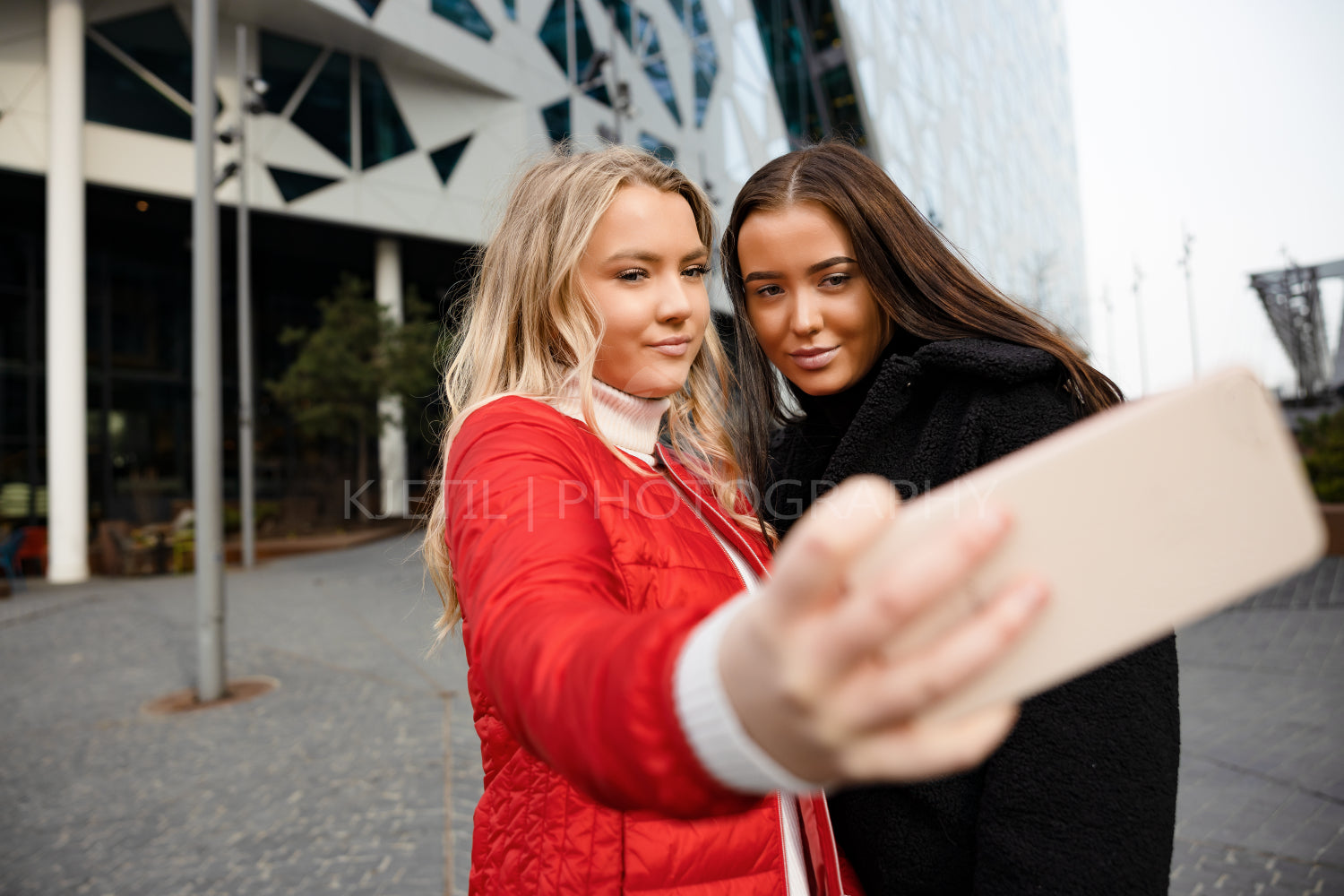 Best Friends Taking Selfie Through Smartphone In City