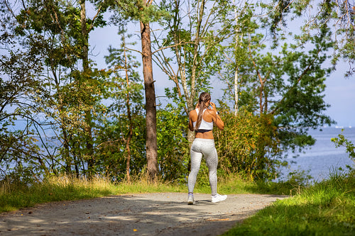 Woman Walking In Woodland During Outdoor Workout
