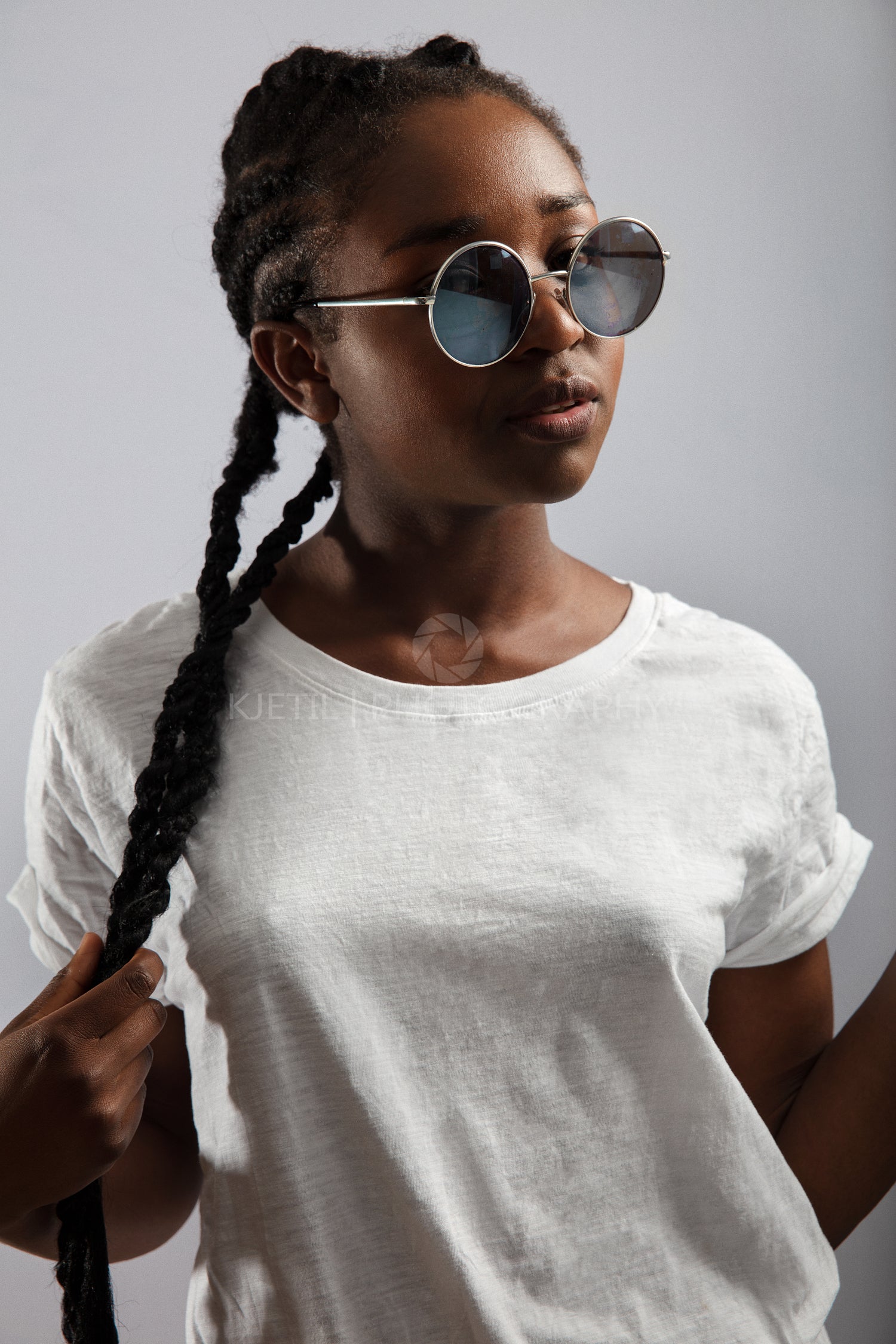 Cool Female Model With Braided Hair and Sunglasses Over Gray Background