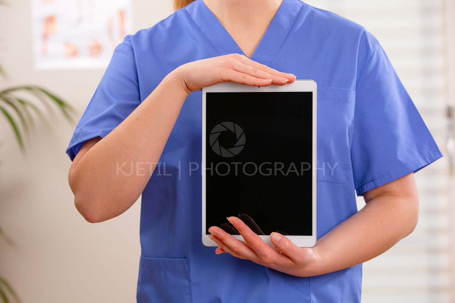 Adult female doctor or nurse show a digital image or report on a tablet