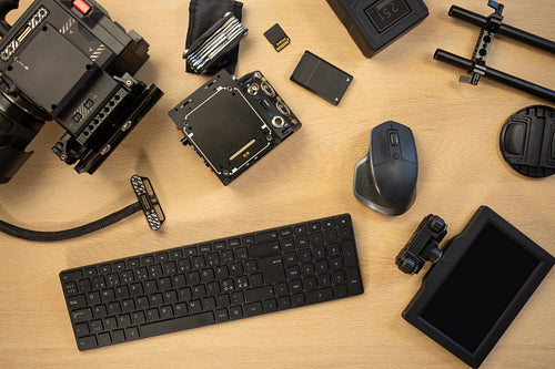 Flat lay of filming accessories with computer parts on table