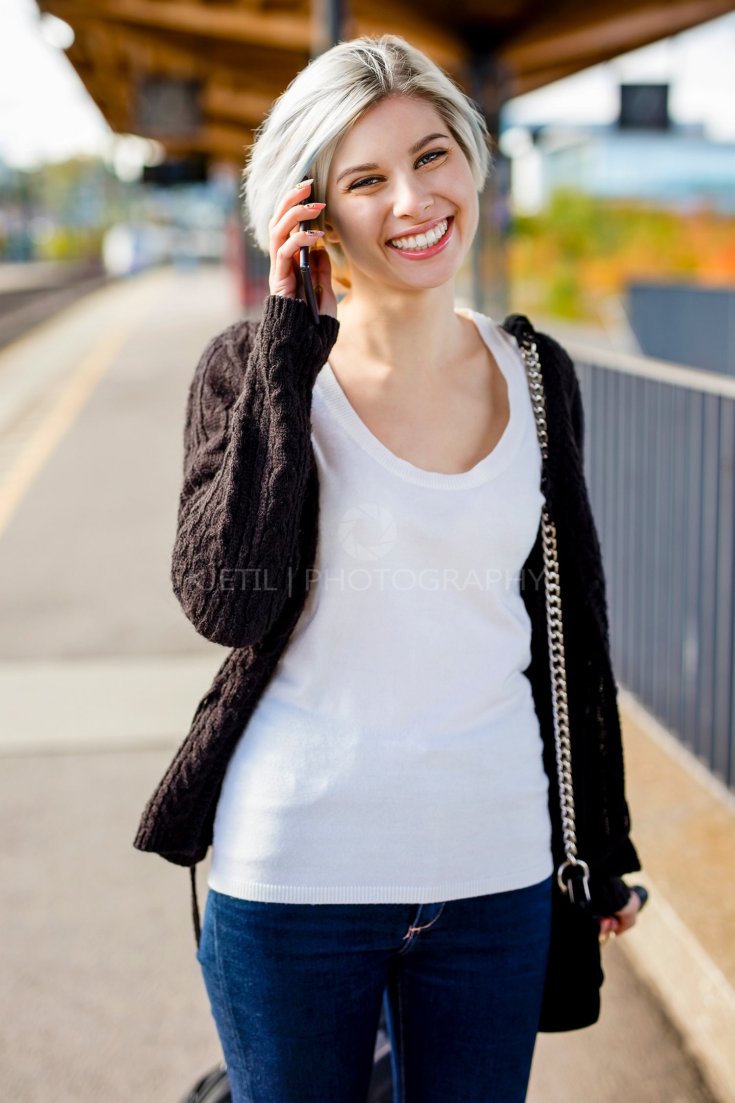 Happy Woman Talking On Mobile Phone At Railroad Platform