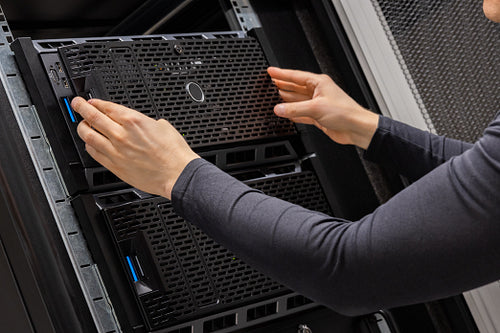 Hands Of Male Technician Installing Servers In Datacenter