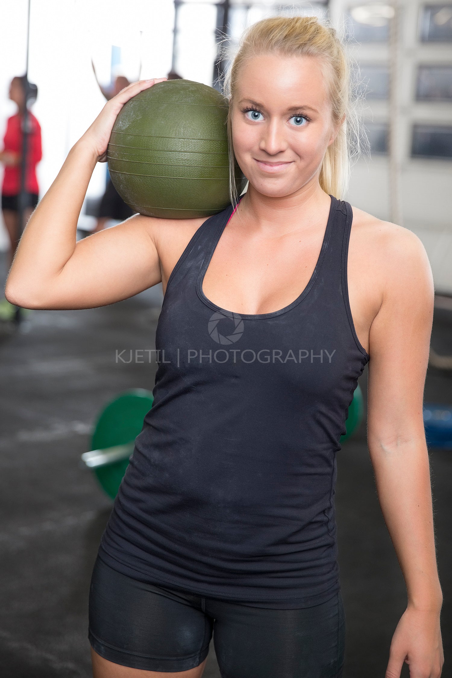 Woman with slam ball at fitness gym center