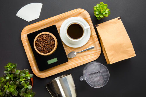 Roasted Beans On Weight Scale With Coffee Cup In Tray