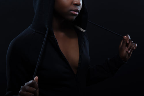 Cropped portrait of a woman with dark skin and attitude wearing hoodie