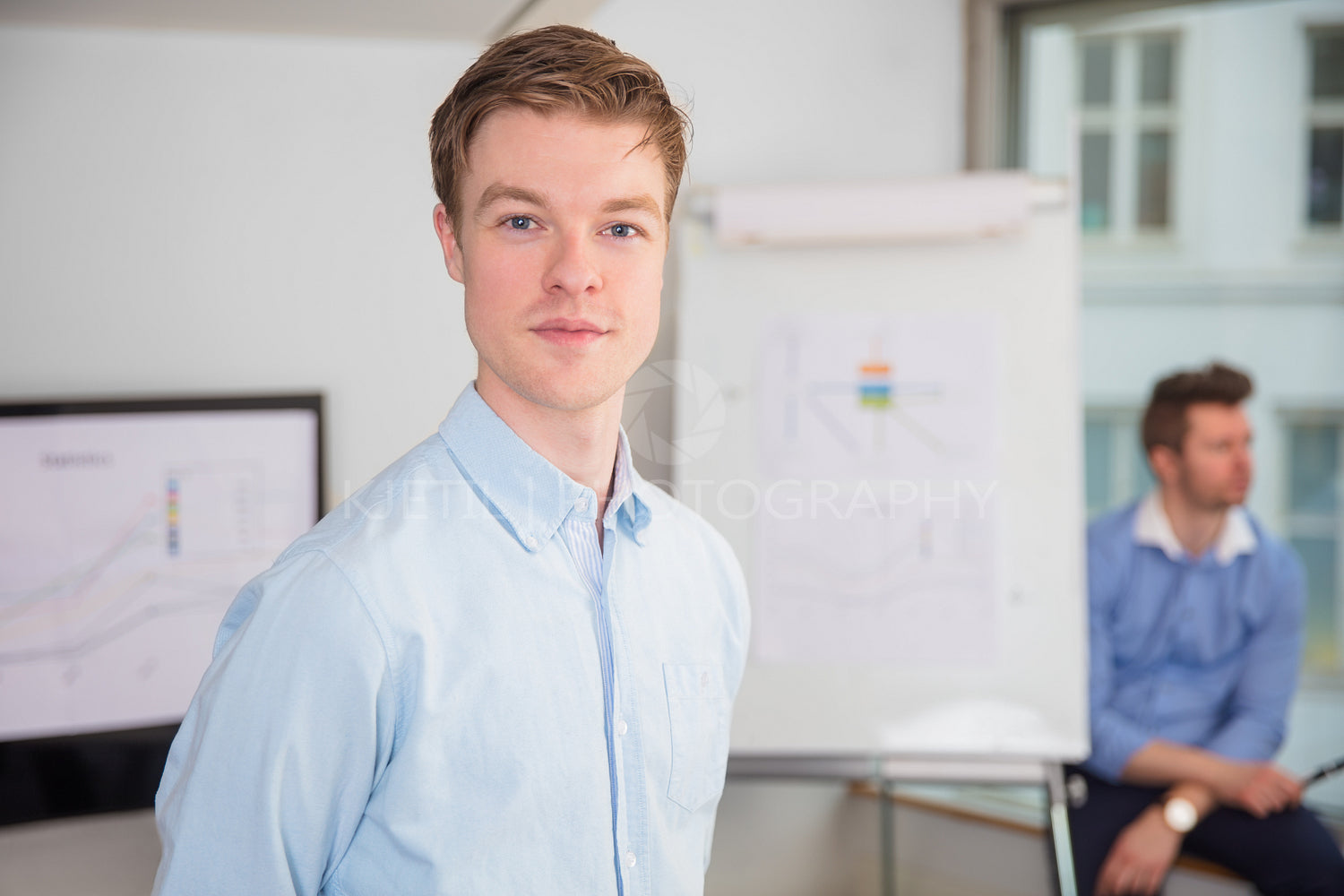 Confident Male Professional Standing In Office