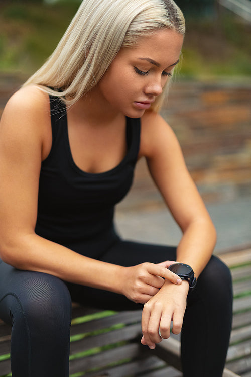 Woman Rests After Workout And Checking Time On Smartwatch