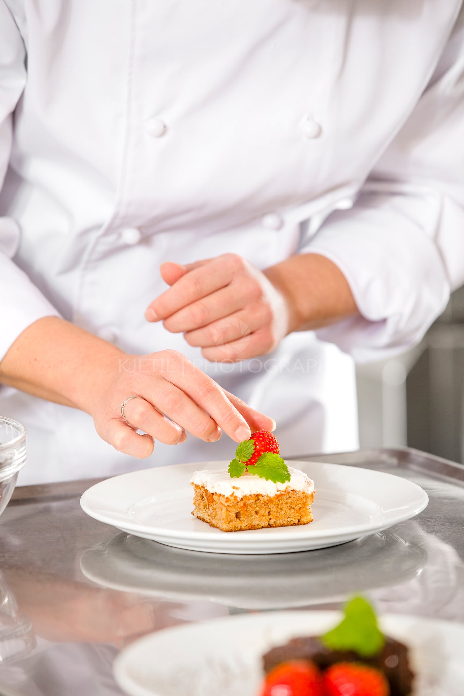 Chef decorate dessert cake with strawberry