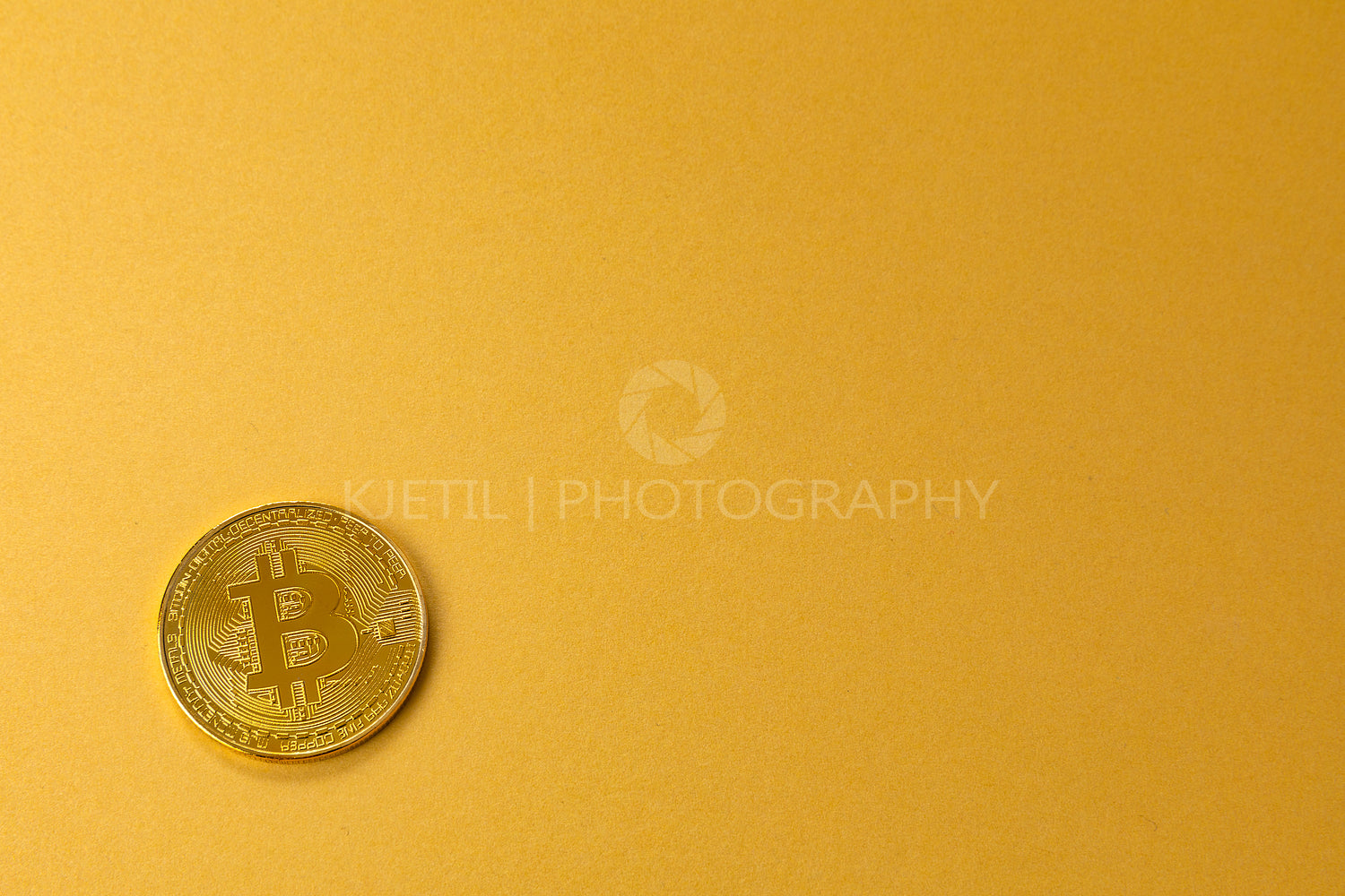 Gold bitcoin crypto currency coin on gold yellow backgound