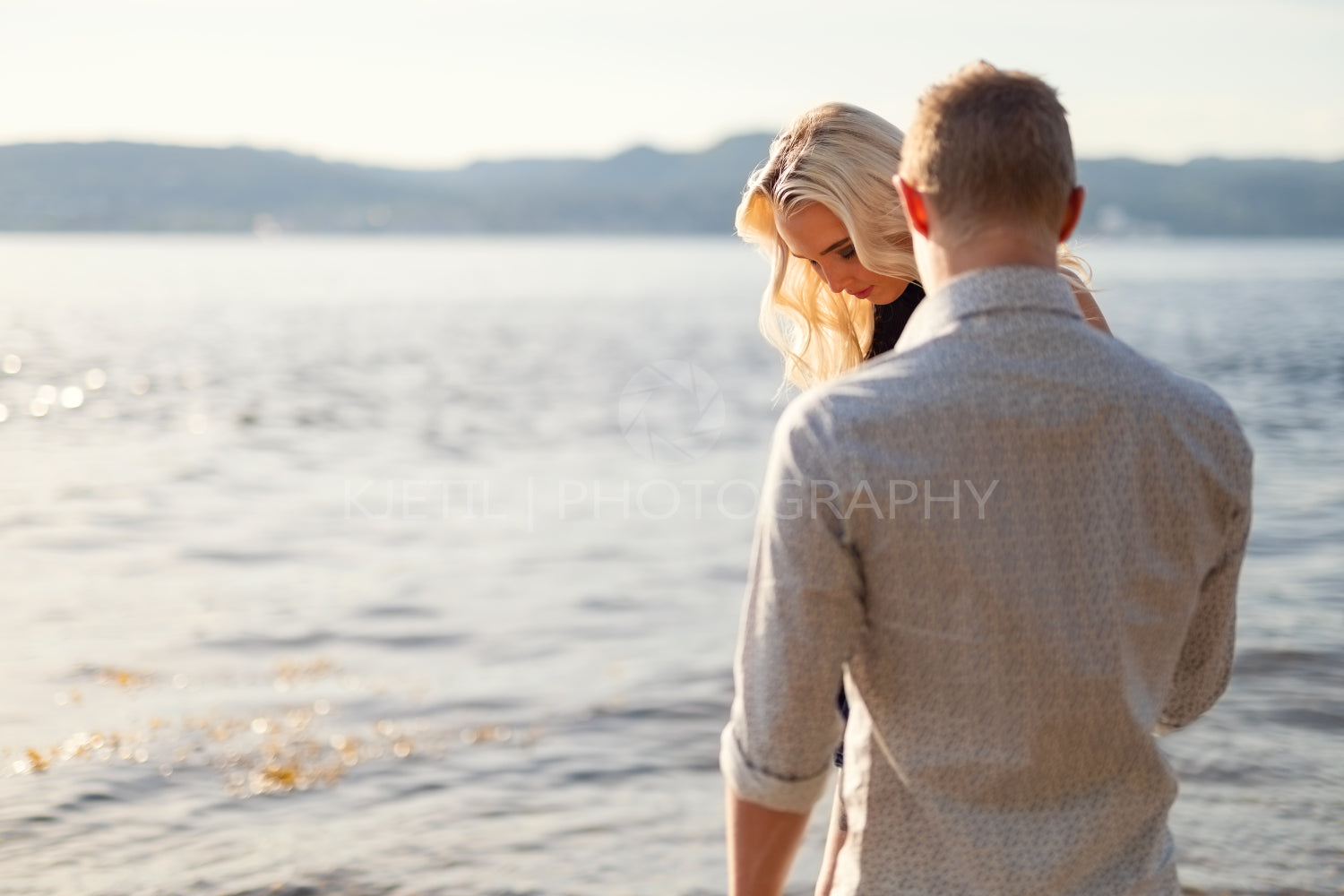 Couple in love holding hands and walking at the beach