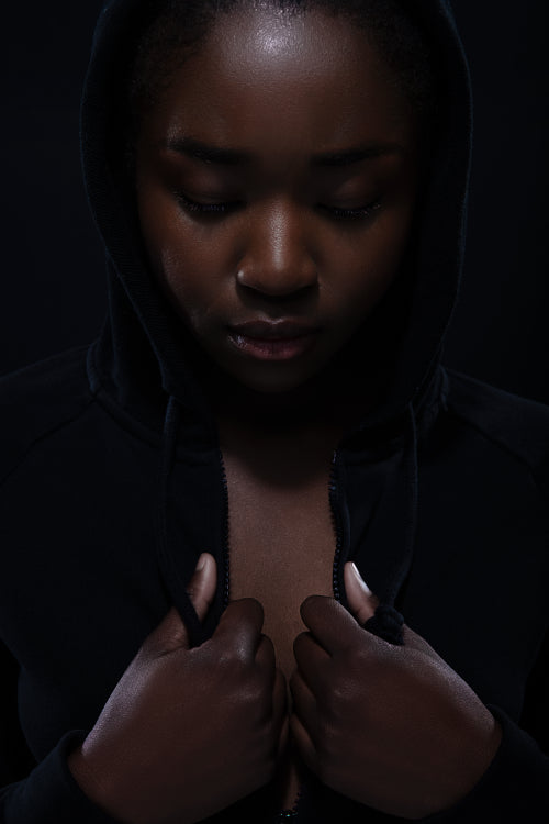 Serious woman with dark skin and cool attitude wearing hoodie
