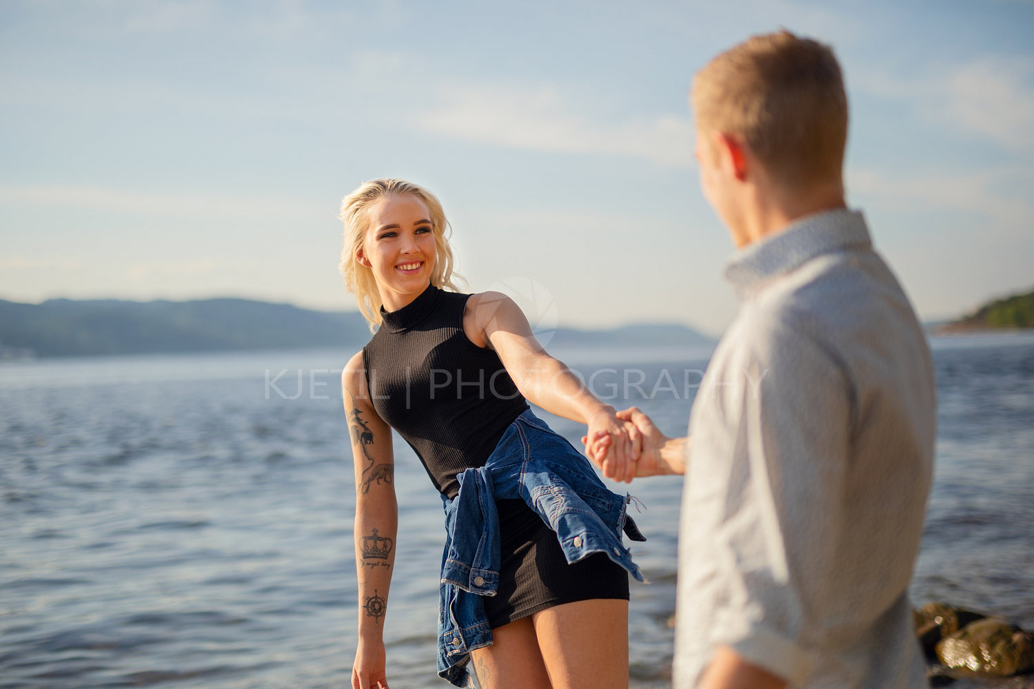 Smiling Woman Looking At Boyfriend Holding Hand