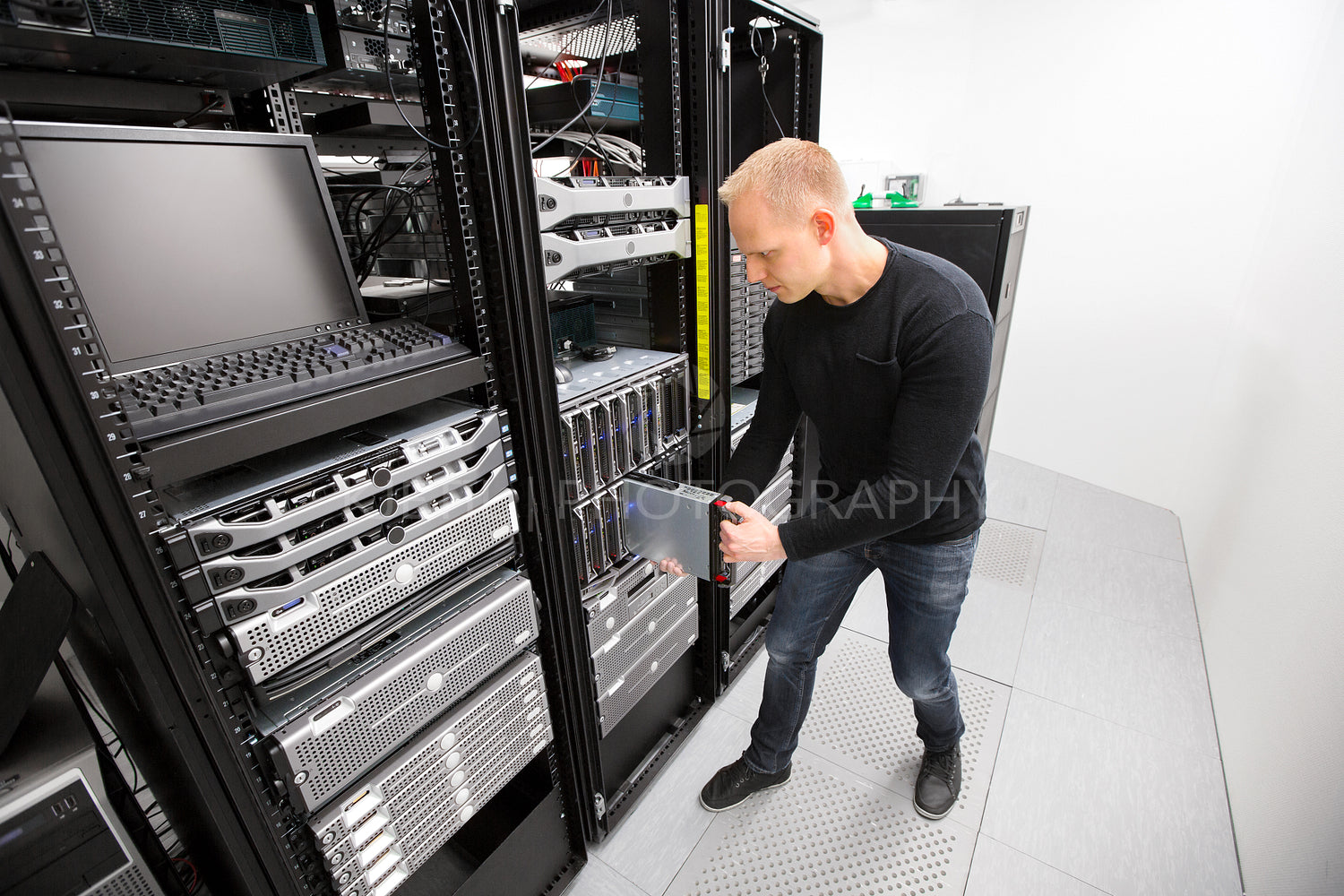 IT Technician Installing Blade Server In Chassis At Datacenter