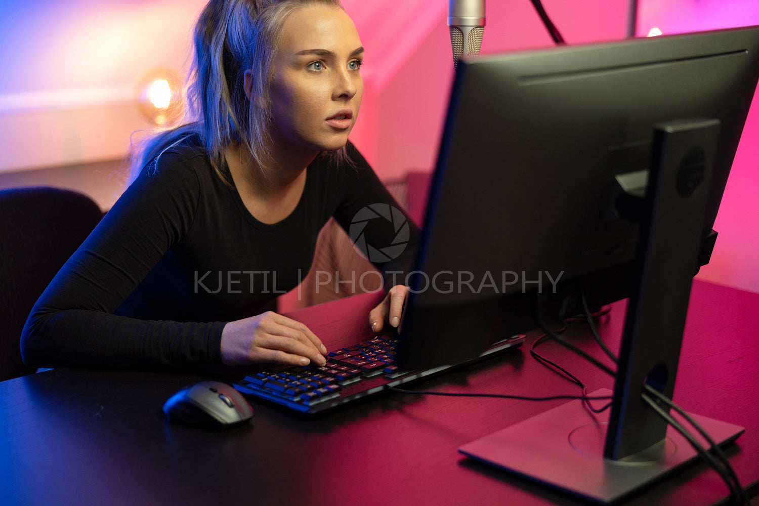 Focused Professional E-sport Gamer Girl with Headset Playing Online Video Game on PC