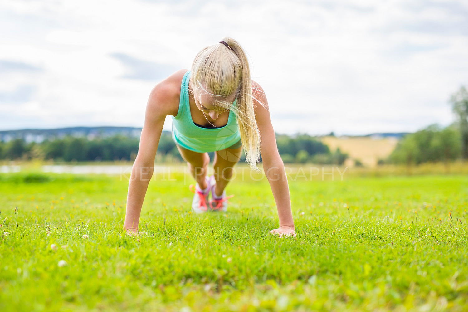 Young woman doing push-ups in the park