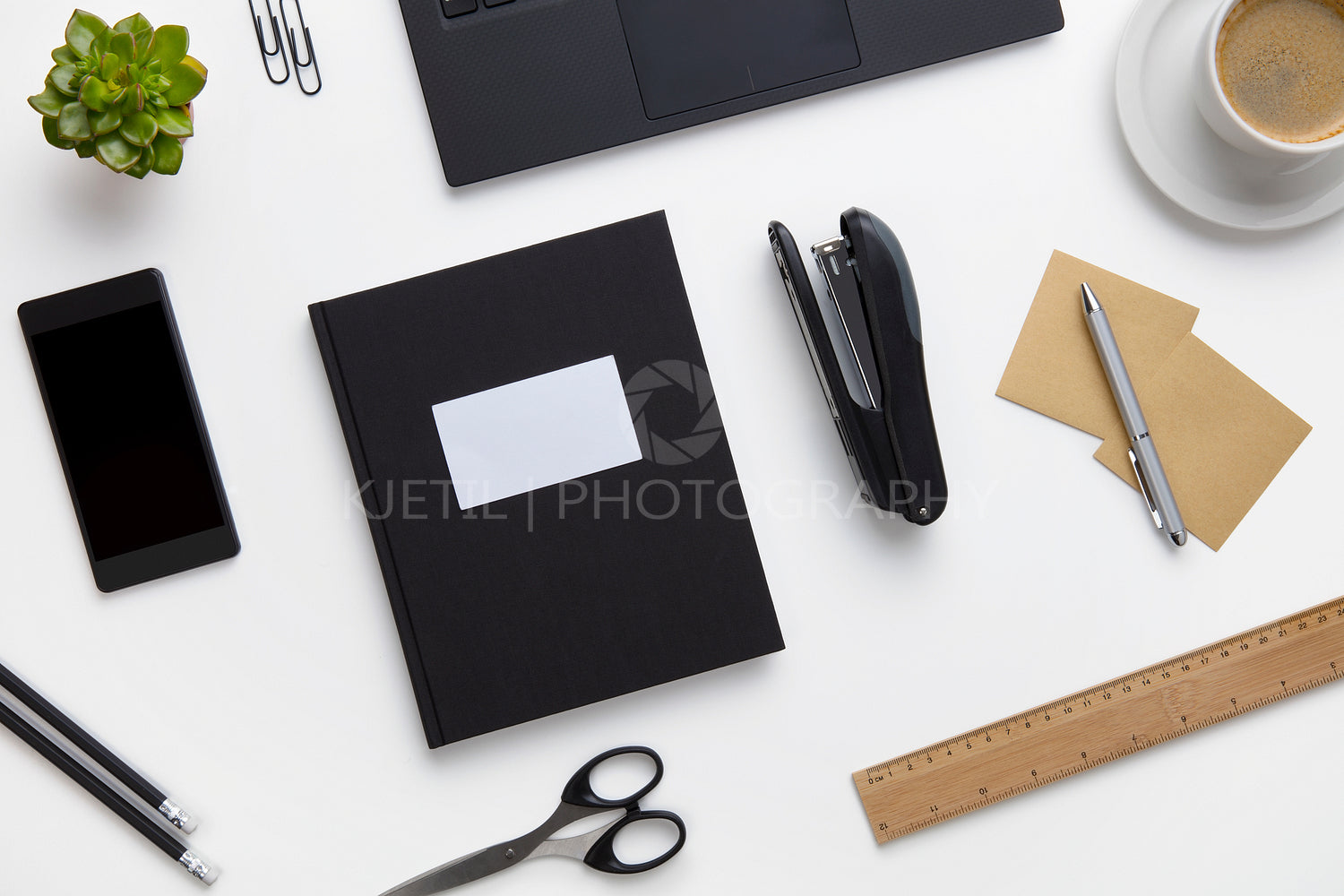 Office Supplies And Devices Arranged On White Desk