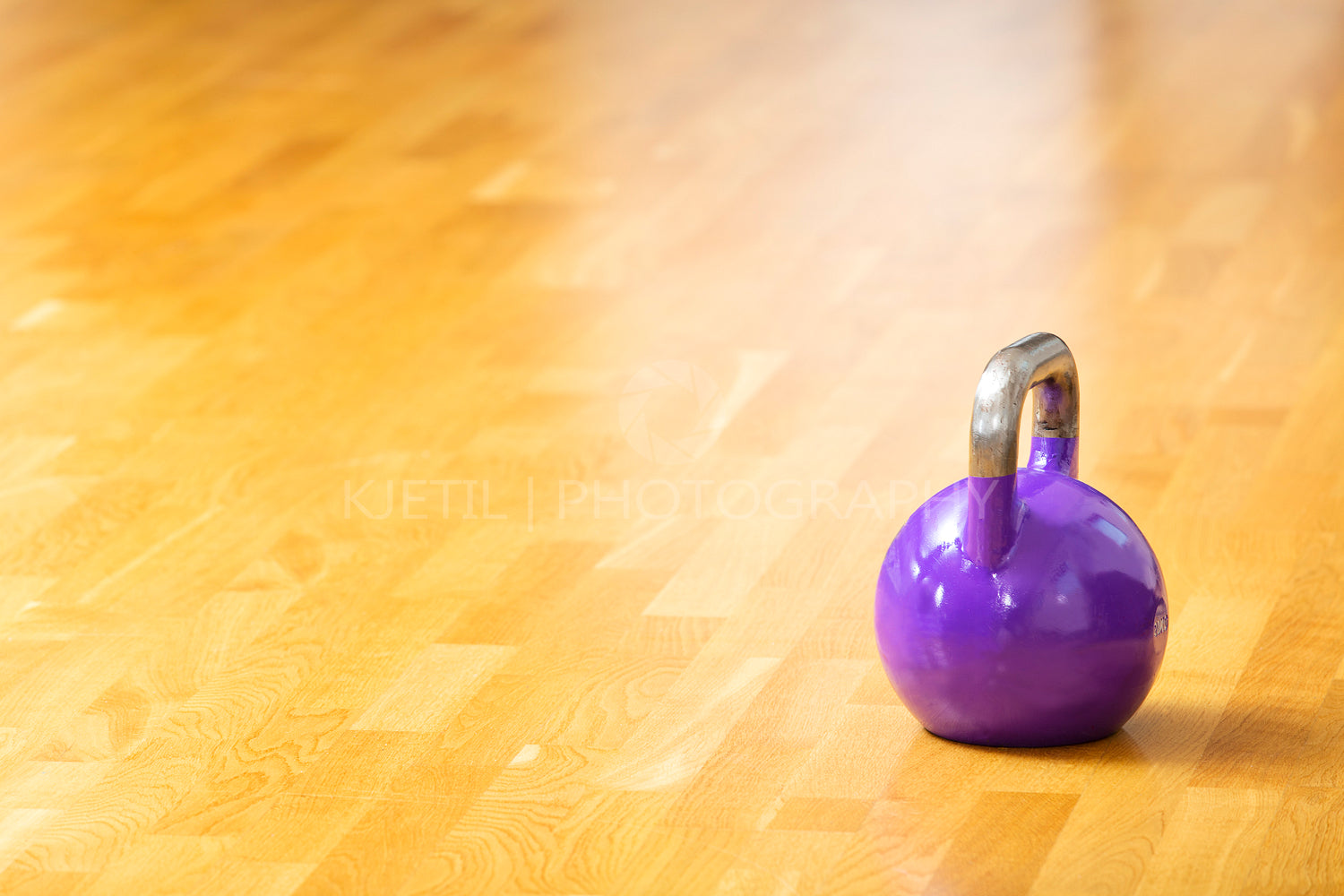 One kettlebell stands on the floor at fitness gym