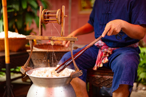 Man Unwinding Silk From Cocoons In Large Hot Pot