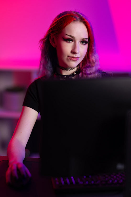 Dedicated female e-sports gamer who streams and plays online video games on her PC