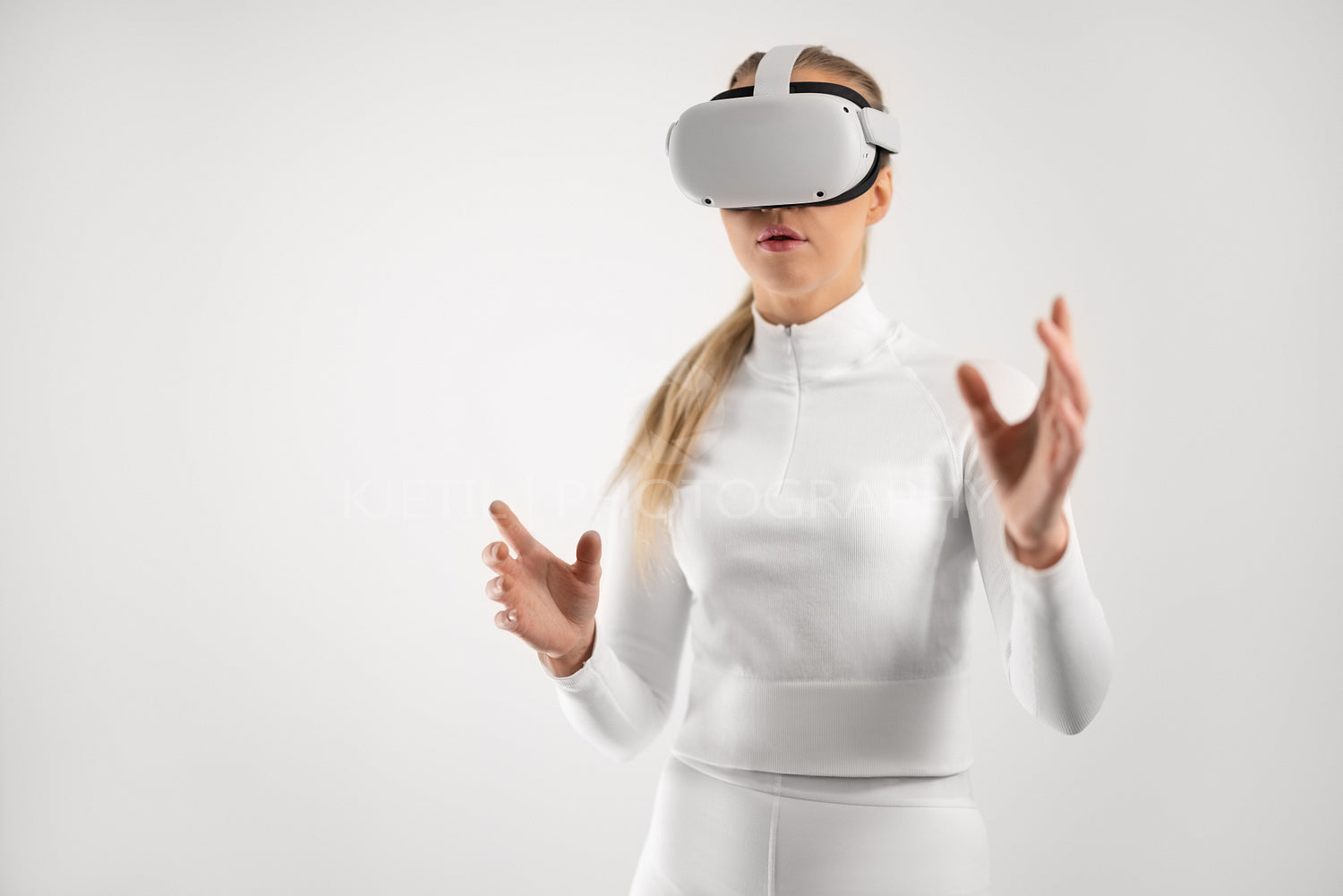 Woman in white wearing VR headset exploring the virtual reality metaverse