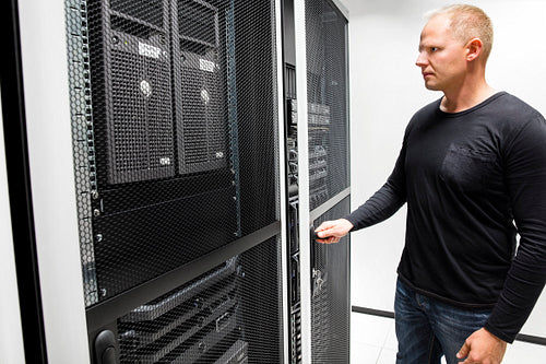 Technician Opening Server Rack Door In Data Center