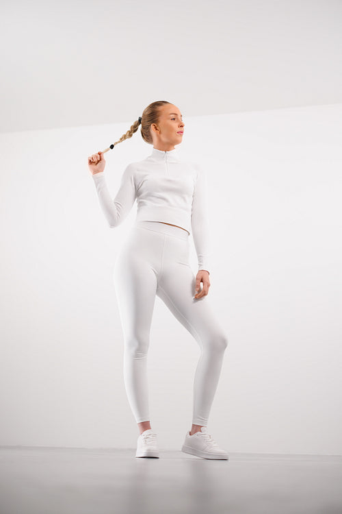 Sporty woman in athleisure against white background