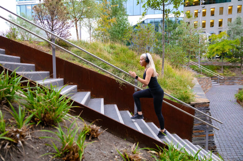 Fit sports women doing hard interval workout in stairs in city park