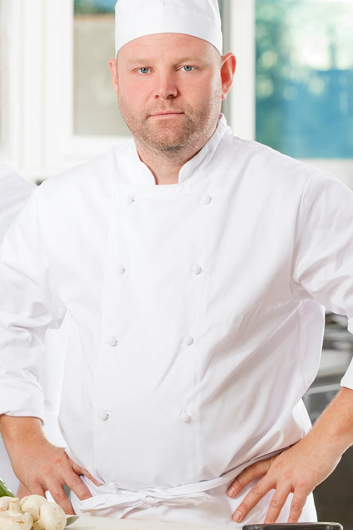 Portrait of confident chef in large kitchen