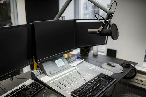 Monitors And Microphone Over Table In Radio Studio