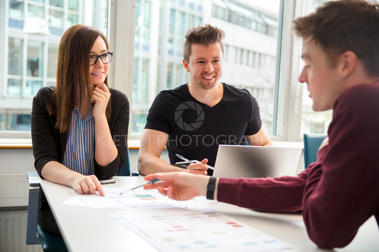 Business People Discussing Over Document In Office