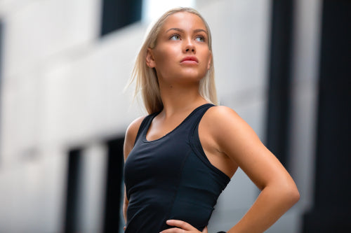 Portrati of confident Fitness Woman in Workout Outfit Standing in City