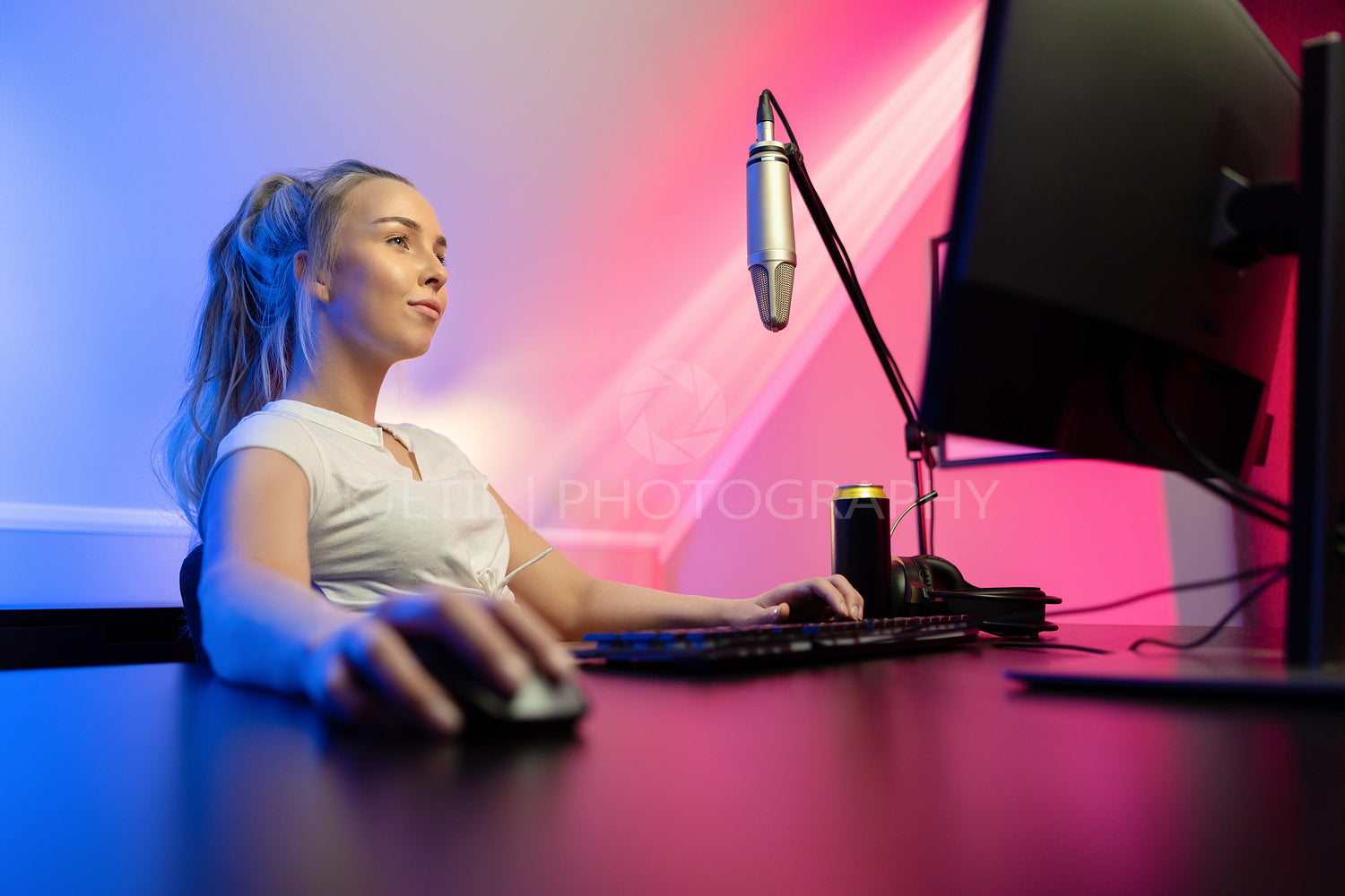 Focused professional gamer girl streams and play online multiplayer video game on PC