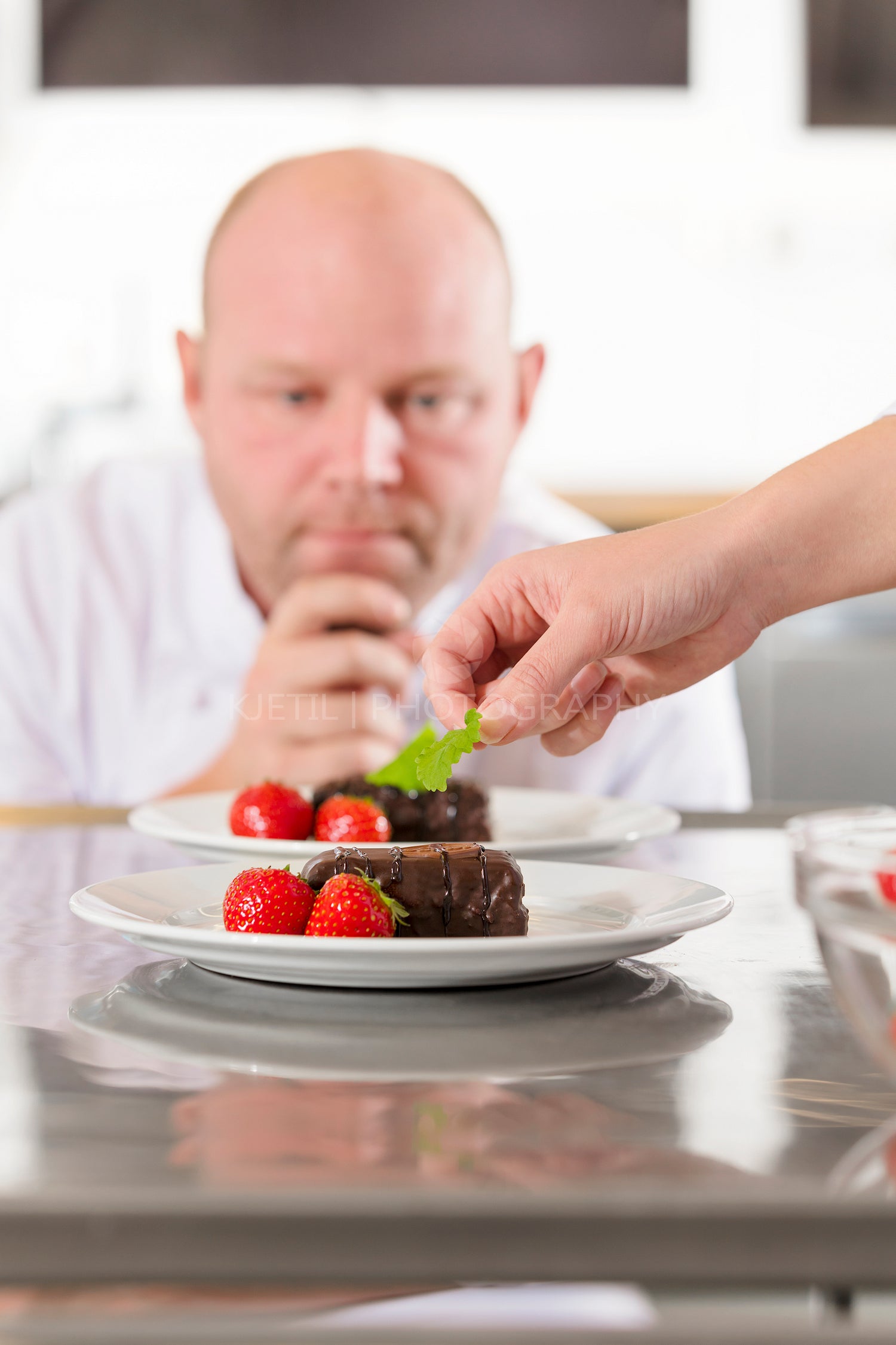 Chef decorate dessert cake with strawberry